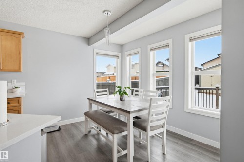 Dining space with light wood-type flooring and a textured ceiling - 4020 157A Avenue, Edmonton, AB - Indoor Photo Showing Dining Room