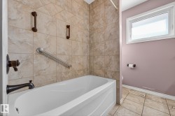 Bathroom featuring baseboards and tub / shower combination - 
