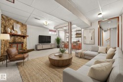 Carpeted living area with a paneled ceiling and a fireplace - 