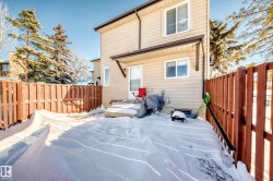 Rear view of property with a fenced backyard - 