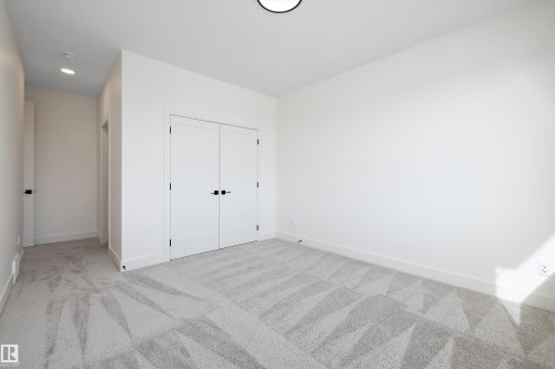 Unfurnished bedroom featuring light carpet, a closet, and recessed lighting - 6871 Knox Loop Sw, Edmonton, AB - Indoor Photo Showing Other Room
