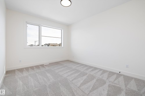 Spare room with light colored carpet - 6871 Knox Loop Sw, Edmonton, AB - Indoor Photo Showing Other Room
