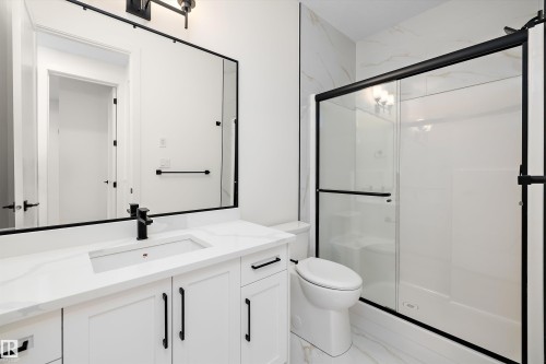 Full bath featuring vanity, a stall shower, and light marble finish floors - 6871 Knox Loop Sw, Edmonton, AB - Indoor Photo Showing Bathroom