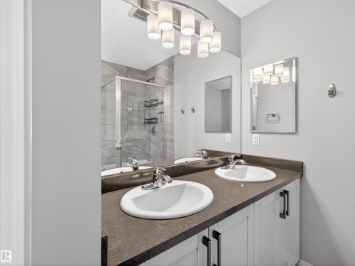 Bathroom featuring double vanity and a shower stall - 1267 Chappelle Boulevard, Edmonton, AB - Indoor Photo Showing Bathroom