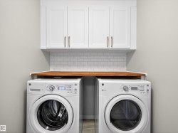 Laundry area with cabinet space and independent washer and dryer - 