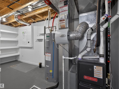 Utilities featuring electric water heater, heating unit, and electric panel - 1267 Chappelle Boulevard, Edmonton, AB - Indoor Photo Showing Basement