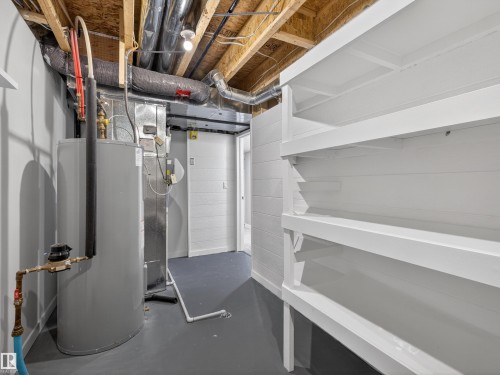 Below grade area featuring electric water heater and heating unit - 1267 Chappelle Boulevard, Edmonton, AB - Indoor Photo Showing Basement
