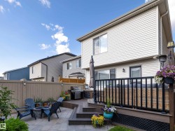 Back of house featuring a wooden deck, a fire pit, and a patio area - 