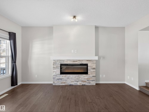 1267 Chappelle Boulevard, Edmonton, AB - Indoor Photo Showing Living Room With Fireplace