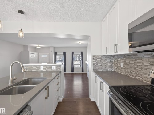Kitchen featuring stainless steel appliances and white cabinets. - 1267 Chappelle Boulevard, Edmonton, AB - Indoor Photo Showing Kitchen With Double Sink With Upgraded Kitchen