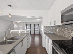 Kitchen featuring stainless steel appliances and white cabinets. - 