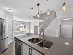 Kitchen featuring stainless steel appliances and white cabinets. - 