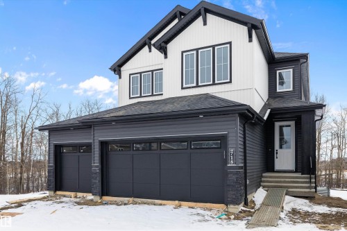 View of front facade with a garage and roof with shingles - 718 Elderberry Close Nw, Edmonton, AB - Outdoor