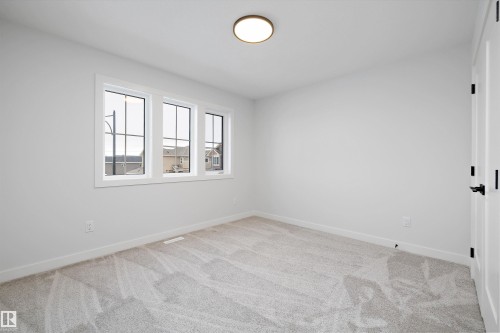 Unfurnished room with baseboards and light colored carpet - 718 Elderberry Close Nw, Edmonton, AB - Indoor Photo Showing Other Room