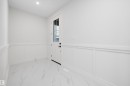 Entryway featuring a decorative wall, wainscoting, marble look tiles, and recessed lighting - 718 Elderberry Close Nw, Edmonton, AB  - Indoor Photo Showing Other Room 