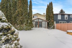 View of front of house featuring a sunroom and a chimney - 