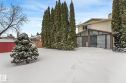 View of front of house with a sunroom and a chimney - 
