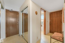 Hallway with light floors and a textured ceiling - 