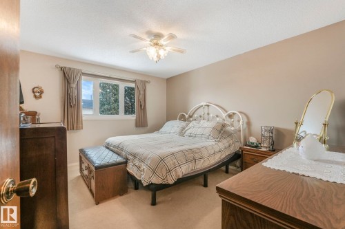 Bedroom with carpet floors, a ceiling fan, and a textured ceiling - 15909 112 B Street Nw, Edmonton, AB - Indoor Photo Showing Bedroom