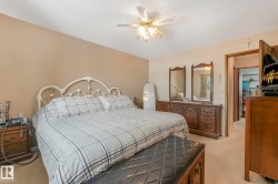 Bedroom with light carpet and ceiling fan - 