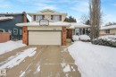Traditional-style house featuring brick siding, concrete driveway, and an attached garage - 15909 112 B Street Nw, Edmonton, AB  - Outdoor With Facade 