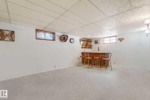 Dining space with a dry bar, a drop ceiling, and carpet flooring - 15909 112 B Street Nw, Edmonton, AB - Indoor