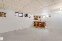 Dining space with a dry bar, a drop ceiling, and carpet flooring - 
