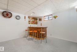 Indoor bar with carpet flooring and a paneled ceiling - 