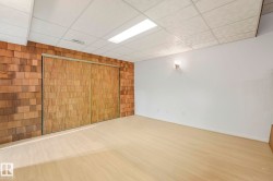 Finished below grade area featuring a paneled ceiling and wood finished floors - 