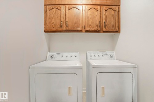 Laundry room featuring cabinet space and independent washer and dryer - 15909 112 B Street Nw, Edmonton, AB - Indoor Photo Showing Laundry Room