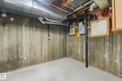 Unfinished below grade area featuring wood walls and electric panel - 