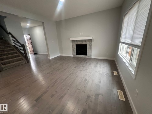 Mainfloor 9455 227 Street, Edmonton, AB - Indoor Photo Showing Living Room With Fireplace