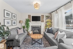 Living room with a tiled fireplace and a textured ceiling - 