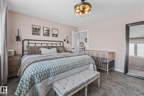 Carpeted bedroom featuring baseboards - 10415 94 Street, Morinville, AB - Indoor Photo Showing Bedroom