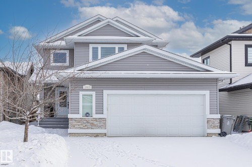 View of front of property featuring stone siding and an attached garage - 10415 94 Street, Morinville, AB - Outdoor
