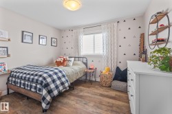 Bedroom with dark wood-type flooring and baseboards - 