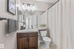 Bathroom featuring vanity, a shower with curtain, and light tile patterned floors - 
