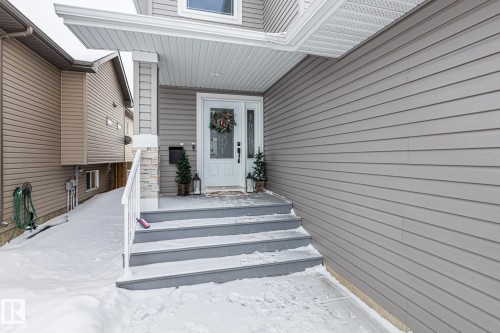 Snow covered property entrance featuring covered porch - 10415 94 Street, Morinville, AB - Outdoor
