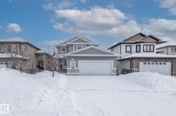 Craftsman-style house with stone siding and a garage - 