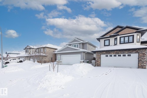 Craftsman house featuring stone siding and a garage - 10415 94 Street, Morinville, AB - Outdoor With Facade