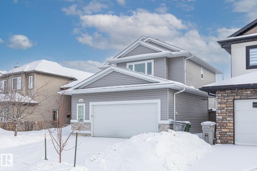 View of front of house with stone siding and a garage - 10415 94 Street, Morinville, AB - Outdoor