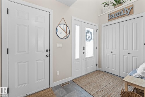 Foyer featuring baseboards and stone finish floors - 10415 94 Street, Morinville, AB - Indoor Photo Showing Other Room