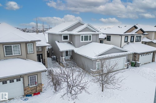 Craftsman inspired home with stone siding, a residential view, and a garage - 10415 94 Street, Morinville, AB - Outdoor With Deck Patio Veranda With Facade