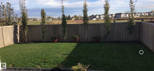 Fenced backyard with a residential view - 10415 94 Street, Morinville, AB - Outdoor