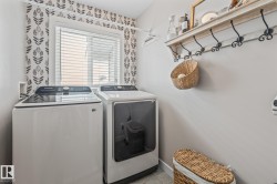 Laundry area with independent washer and dryer and baseboards - 