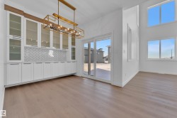 Unfurnished dining area with hanging lights and light wood-style floors - 