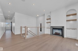 Unfurnished living room with built in features, light wood-style floors, recessed lighting, and a fireplace - 