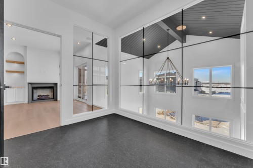 Interior space with a fireplace, hanging lights, and vaulted ceiling - 95 Eldridge Point(E), St. Albert, AB - Indoor Photo Showing Other Room