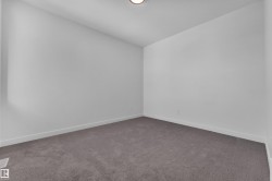 Empty room with carpet floors and baseboards - 