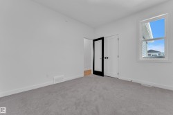 Unfurnished bedroom featuring baseboards and light carpet - 
